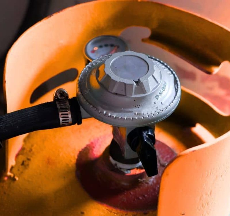 Close-up of LP gas cylinder and regulator for home use.